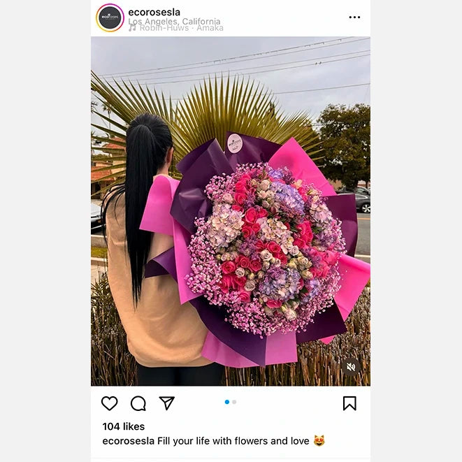 Woman holding flowers in front of building